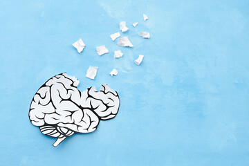 human brain made of paper on a blue background destruction of the human brain