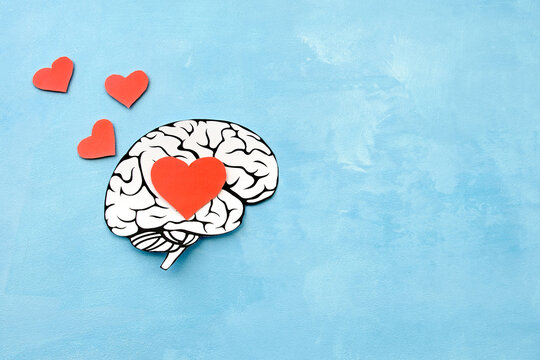 hearts fly out of the brain of a man in love from paper on a blue background