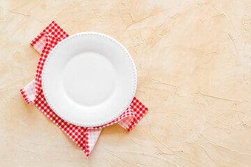 Top view of empty plate on napkin. Table setting for dinner
