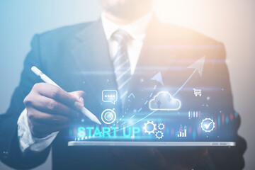 Business start up concept with online business icon and global internet network connection via technology tablet.