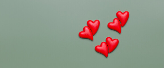 Red hearts on a light green background. St. Valentine's Day. Place for text