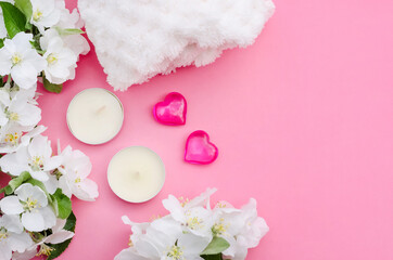 Valentine's day pink background with hearts, candles and flowers with copy space, spa treatment theme