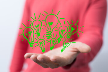 Hands holding green nature in the light bulb