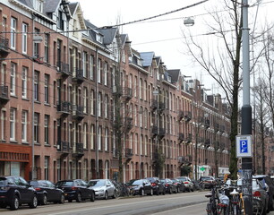 Fototapeta na wymiar Amsterdam Baarsjes District Street View with Building Facades and Parked Cars, Netherlands