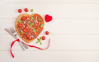 Valentine's day background with pizza heart on white wooden background with copy space