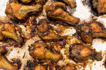 Fried chicken wings on a white baking sheet