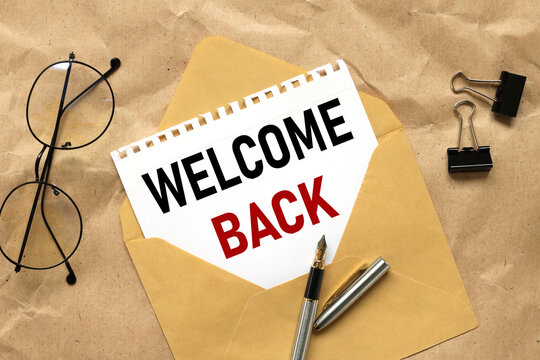 Welcome back. text on paper in an envelope