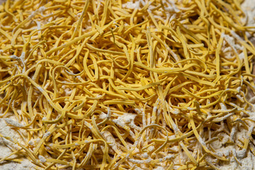 Egg noodles in full screen. Dry homemade noodles. Traditional pasta