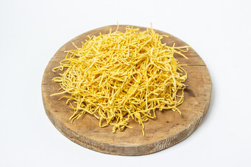 Egg noodles on a white background. Dry homemade noodles on a wooden board. Traditional pasta