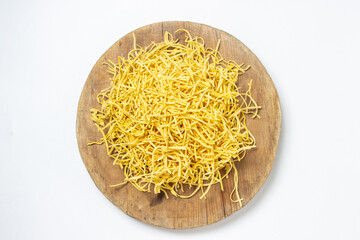Egg noodles on a white background. Dry homemade noodles on a wooden board. Traditional pasta