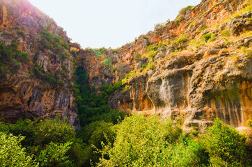 Picturesque nature landscape view of Hell and Heaven Cave. There's small cave on bottom. It's one of deepest  sinkholes in Turkey. Blue sky background. Travel and tourism concept