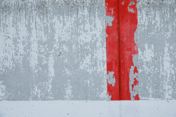 Grey and white cement wall with red painted stripe, 