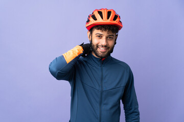 Young Moroccan cyclist man isolated on purple background laughing - obrazy, fototapety, plakaty
