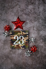 colorful shiny bows and star, 23 number on gift box on dark grey background. Present for day of defenders of fatherland. 23 february holiday. gift for man. minimal design. flat lay
