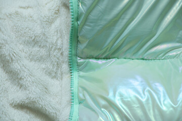 warm children's winter green puffy jacket as background ,winter puffy jacket ,fashion © Виктория Котлярчук