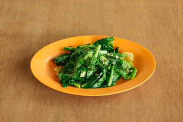Fried Kai Lan Oyster Sauce  with fried garlic (Chinese Broccoli) on wooden background top view food