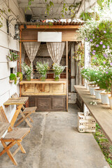 Fototapeta na wymiar Vintage garden with wooden bench, flower pots