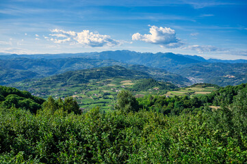Fototapeta na wymiar Spring green valley panoramic landscape in north Italy