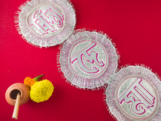 bengali hindu festival saraswati puja and vasant panchami.ink pot made of clay, stick pen, marigold...