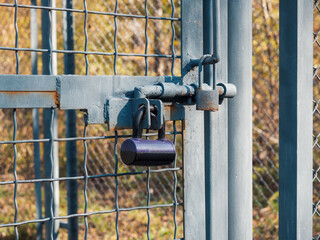 Selective focus, texture of a metal old lattice fence against the blue sky, fence lattice, lattice background, cell. High quality photo