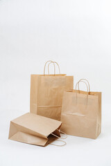 Composition of three empty brown paper bags over white background.