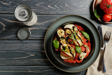 Caprese salad with tomato, mozzarella, basil and olive oil. Flat lay.