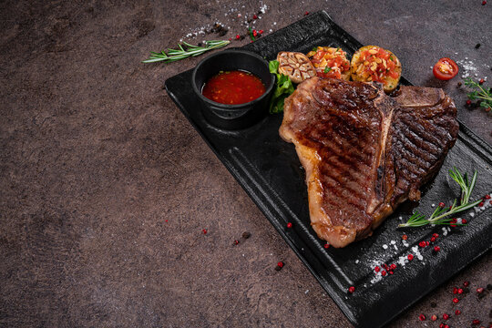 steak fried tibon with corn and wine sauce on the table.