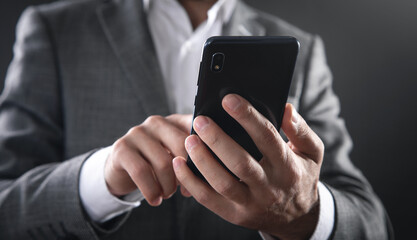 Caucasian businessman using smartphone in office.