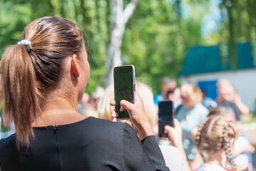 A young woman is filming a meeting, a workers' strike.