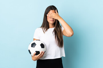 Young football player brazilian girl isolated on blue background covering eyes by hands. Do not want to see something