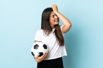 Young football player brazilian girl isolated on blue background has realized something and intending the solution