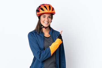 Young cyclist brazilian girl isolated on white  background pointing to the side to present a product