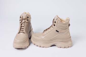 Beautiful shoes on an isolated white studio background. Fashionable beige women's shoe. Elegant stylish footwear.