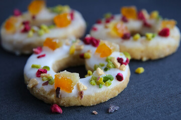 shortbread cookies with candied fruits on a dark background