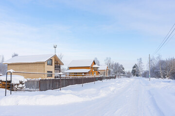 Street with cottages in the village in winter