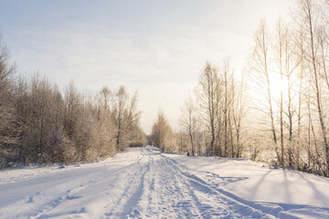 Fototapeta na wymiar Snow covered road in the forest in winter