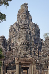 Adventure of exploring mystic Bayon temple in the impressive Khmer ruin city Angkor Thom (vertical image), Siem Reap, Cambodia