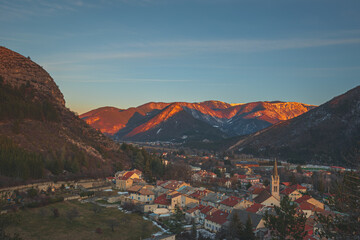 A panoramic wide landscape view of Veynes, an old town in the French Alps, during the sunset