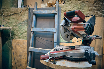 Cross cut saw machine at carpentry workshop. Electric carpenter tools