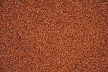 Photo of the red wall of the building. Plaster.
