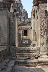 Adventure of exploring mystic Bayon temple in the impressive Khmer ruin city Angkor Thom (vertical image), Siem Reap, Cambodia