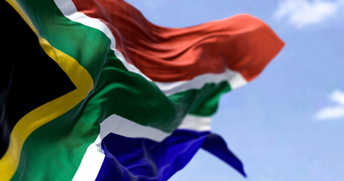 Detailed close up of the national flag of South Africa waving in the wind on a clear day
