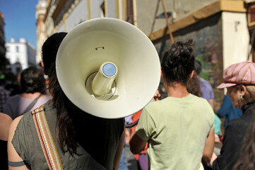 Feminist demonstration of women with megaphone. 