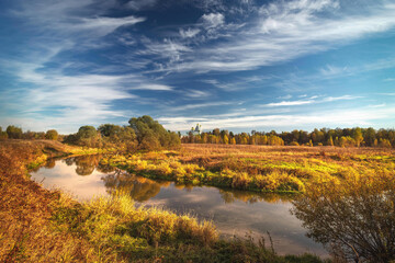 golden autumn landscape of New Jerusalem Monastery and Istra River, sky and clouds, Istra, Moscow region, Russia