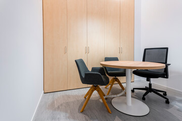 Office furniture composed of table and chairs of contemporary and modern design in office room