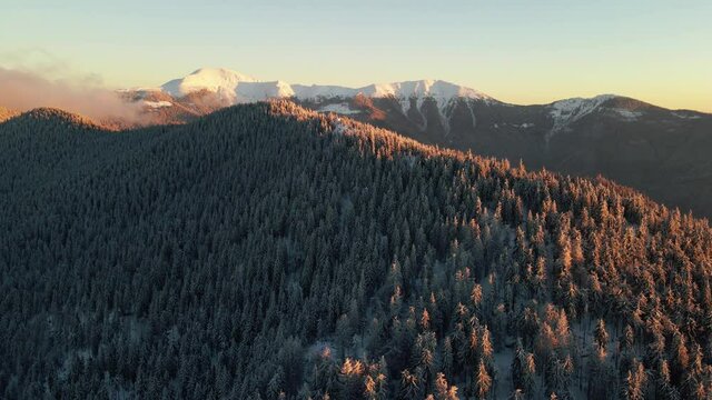 Aerial footage of white mountain peaks in winter
