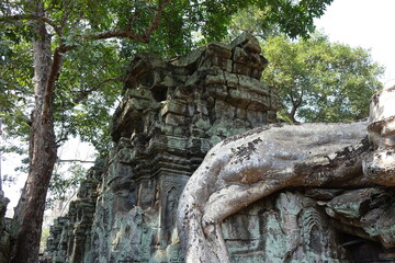 Fototapeta na wymiar Adventure of exploring mystic Ta Prohm temple overgrown by jungle trees (horizontal image), Siem Reap, Cambodia