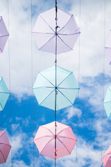 Colorful umbrella decorations against a cloudy sky. 