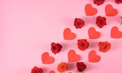Red and orange roses and pictures of hearts. Valentine's day pattern. Copy space.