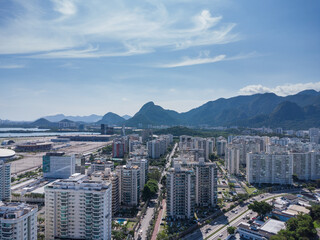 Aerial view of Jacarépagua in Rio de Janeiro, Brazil. Residential buildings and mountains in the background. Sunny day. Drone photo